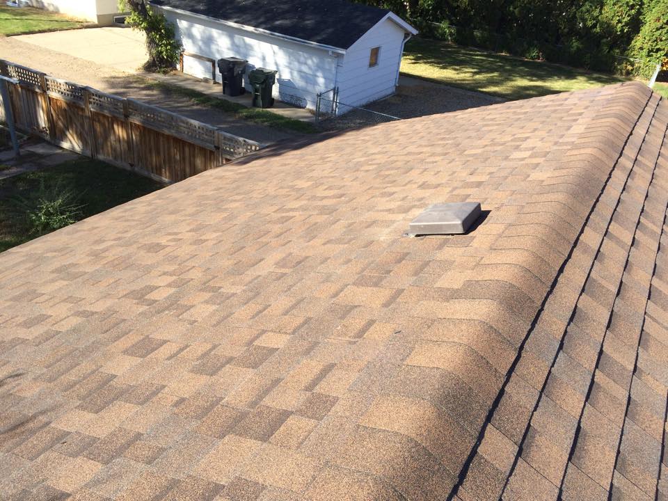 Aerial view of residential roof with brown shingles